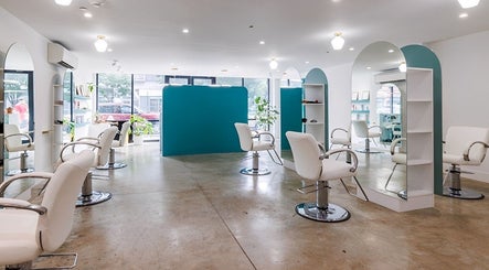 Modern salon interior at Silky | The Healthy Hair Experts 2, Brooklyn, New York, US, featuring sleek white chairs.