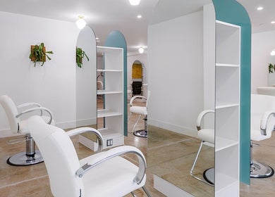 Modern salon interior at Silky | The Healthy Hair Experts 2, Brooklyn, New York, US with white chairs and mirrors.