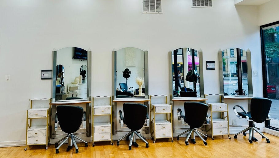 Chic salon interior of Silky | The Healthy Hair Experts 3 in New York, New York, US, showcasing stylish workstations.