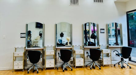 Chic salon interior of Silky | The Healthy Hair Experts 3 in New York, New York, US, showcasing stylish workstations.