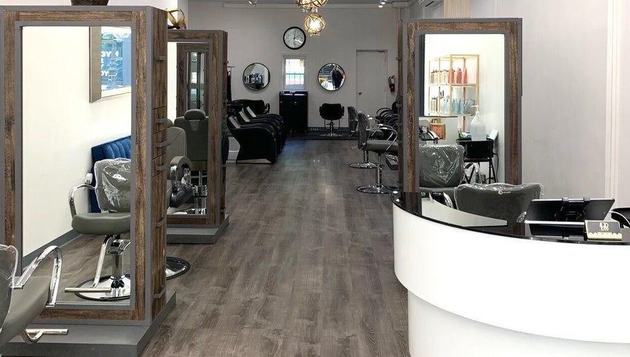 Modern salon interior at Silky | The Healthy Hair Experts, New York, New York, US, featuring stylish seating and mirrors.
