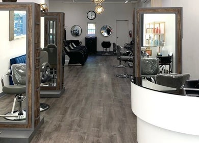 Modern salon interior at Silky | The Healthy Hair Experts, New York, New York, US, featuring stylish seating and mirrors.
