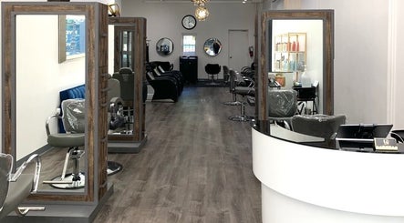 Modern salon interior at Silky | The Healthy Hair Experts, New York, New York, US, featuring stylish seating and mirrors.