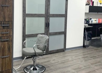 Modern salon interior at Silky | The Healthy Hair Experts, New York, New York, US. Sleek styling chairs and equipment.