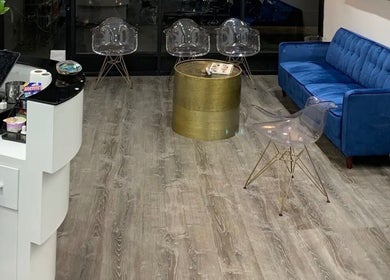 Modern waiting area at Silky | The Healthy Hair Experts, featuring blue sofa and chic decor in New York, New York, US.