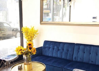 Cozy seating with bright flowers at Silky | The Healthy Hair Experts, New York, New York, US.