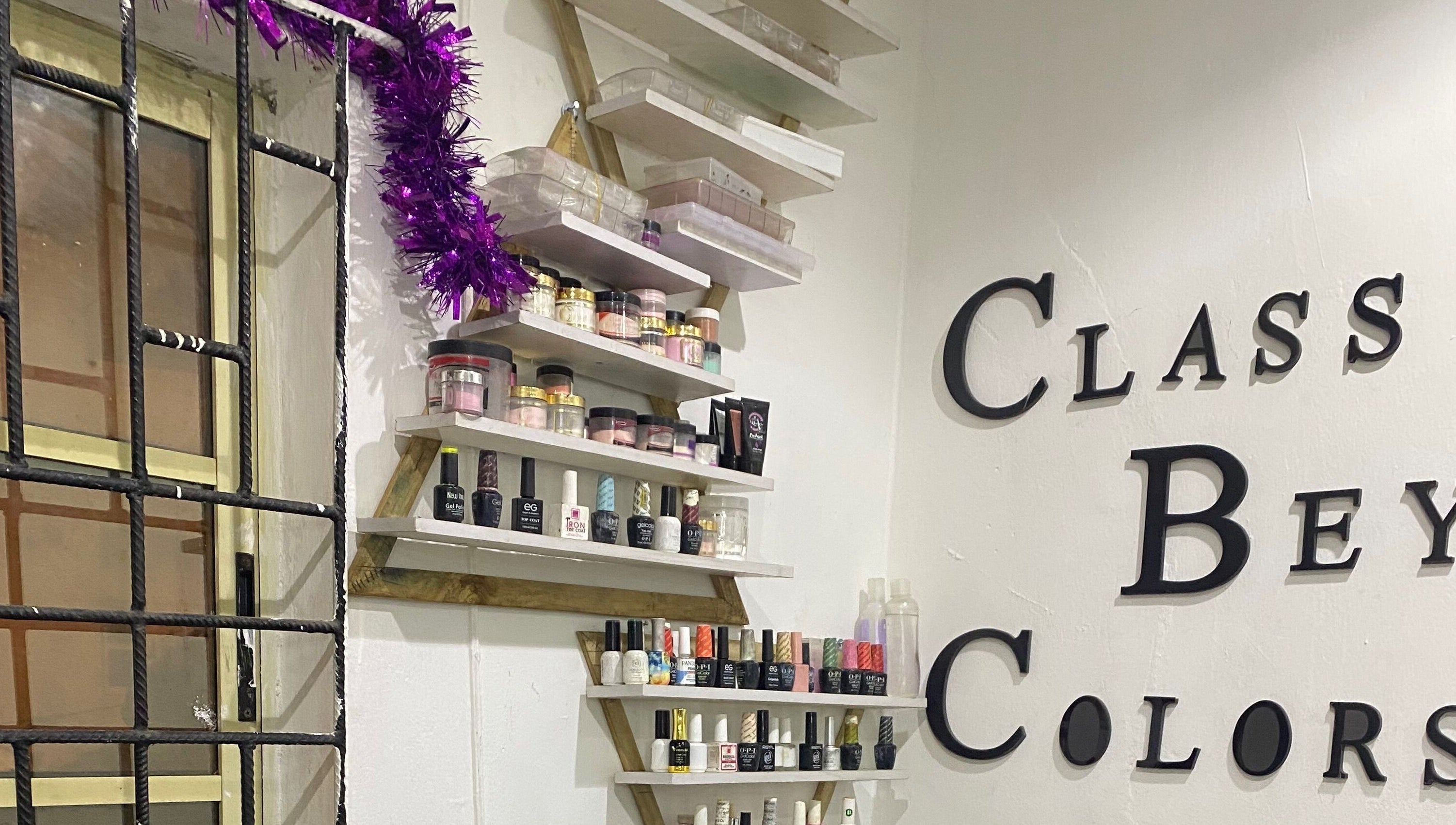 Class Beyond Colors venue in Lekki, Lagos, NG showcasing nail products on artistic shelves.