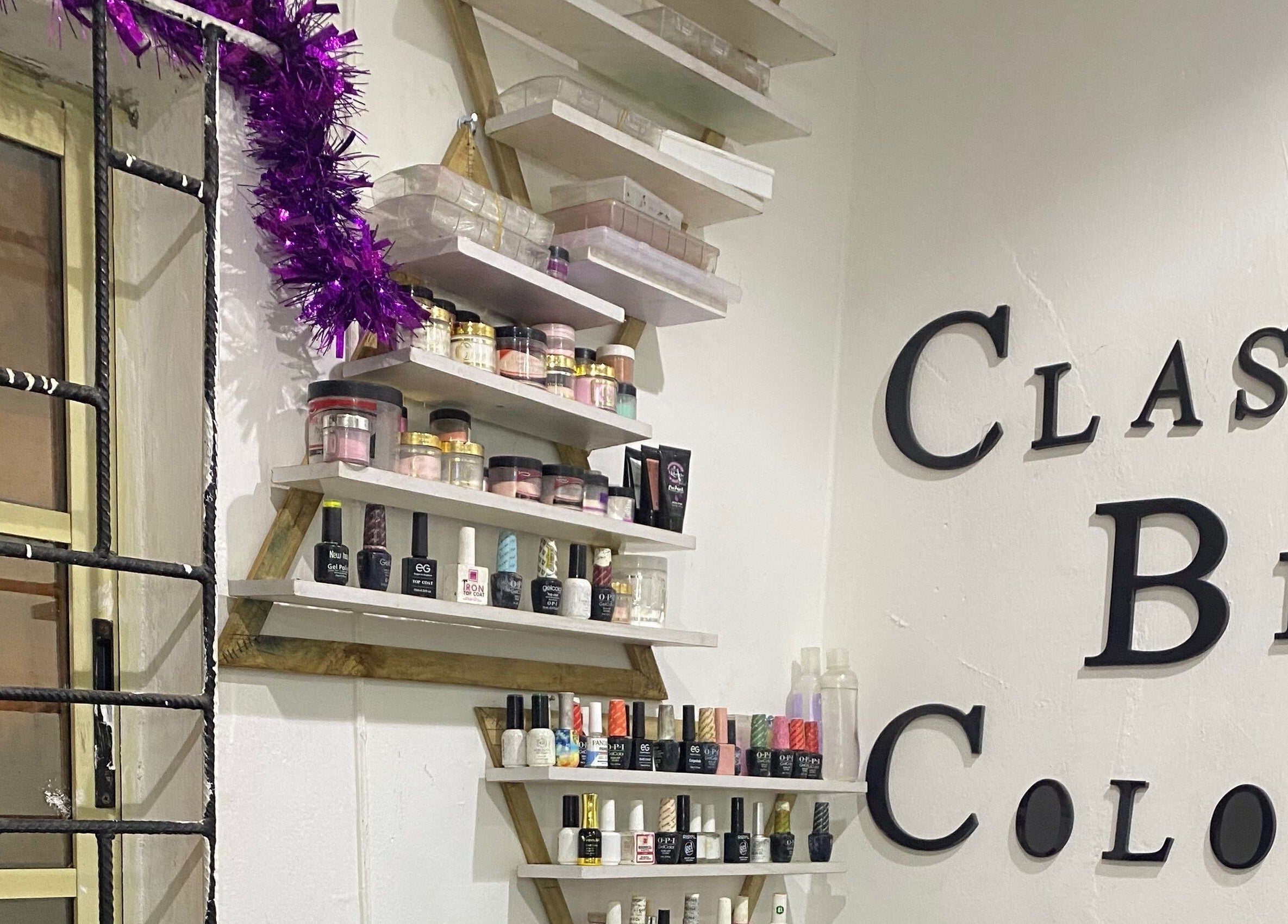 Class Beyond Colors venue in Lekki, Lagos, NG showcasing nail products on artistic shelves.