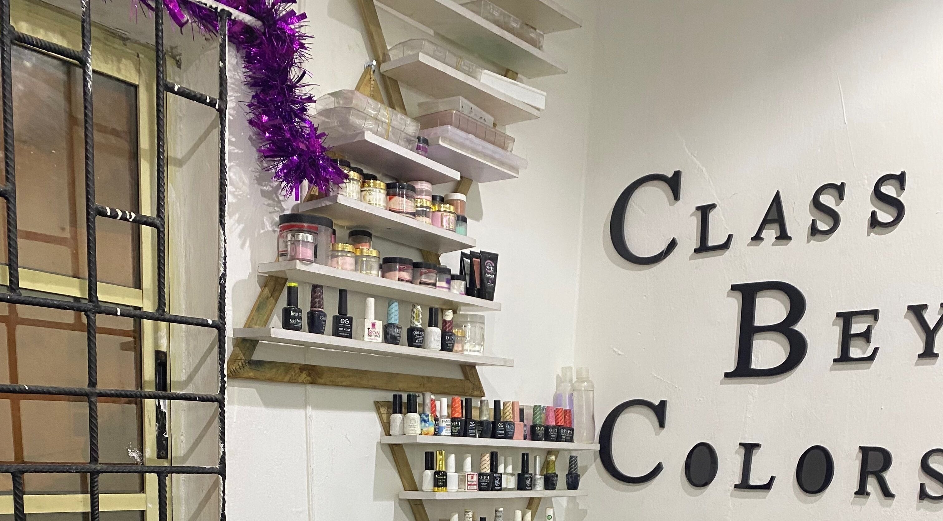 Class Beyond Colors venue in Lekki, Lagos, NG showcasing nail products on artistic shelves.