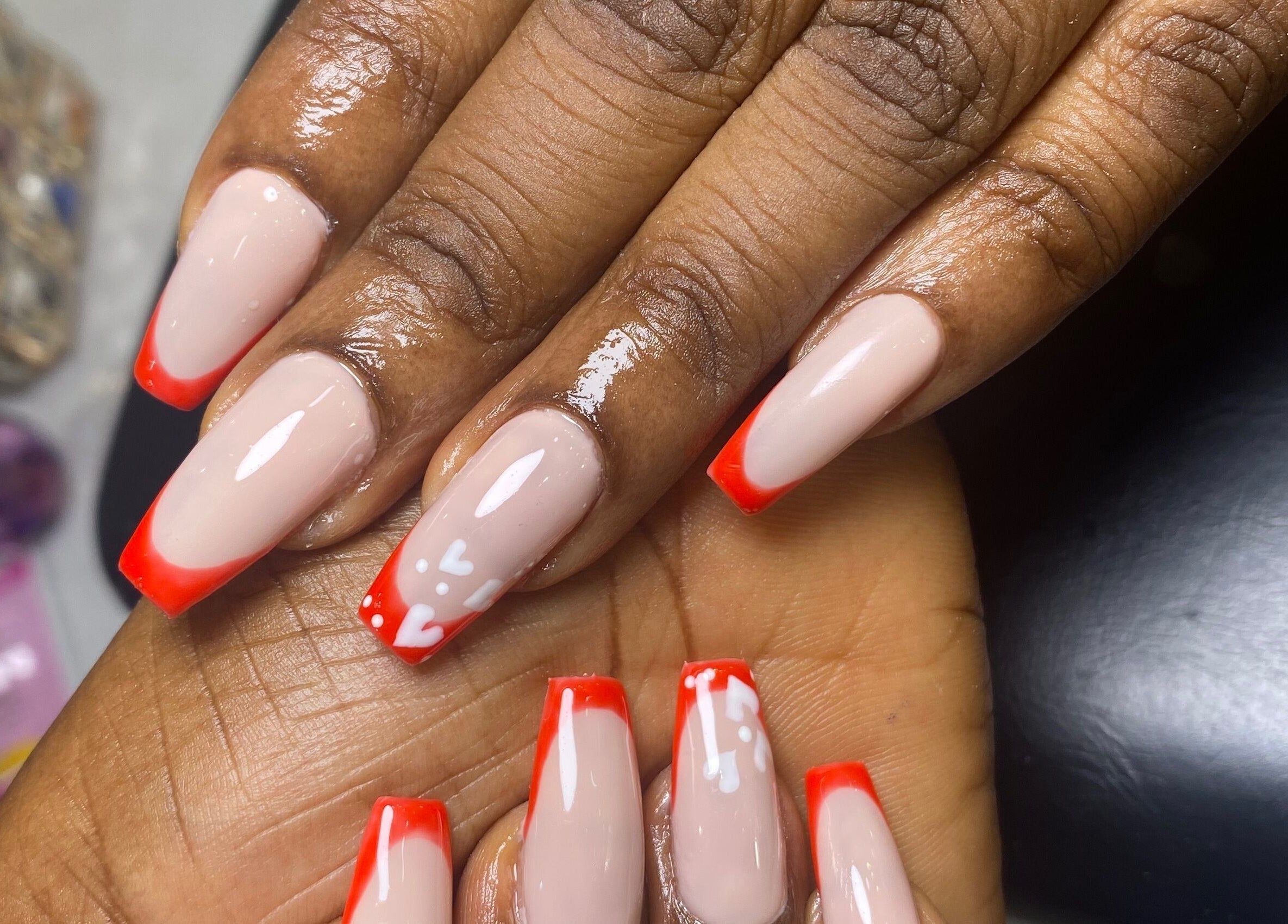 Elegant nails with bright red tips at Class Beyond Colors, Lekki, Lagos, NG showcasing expert nail artistry.