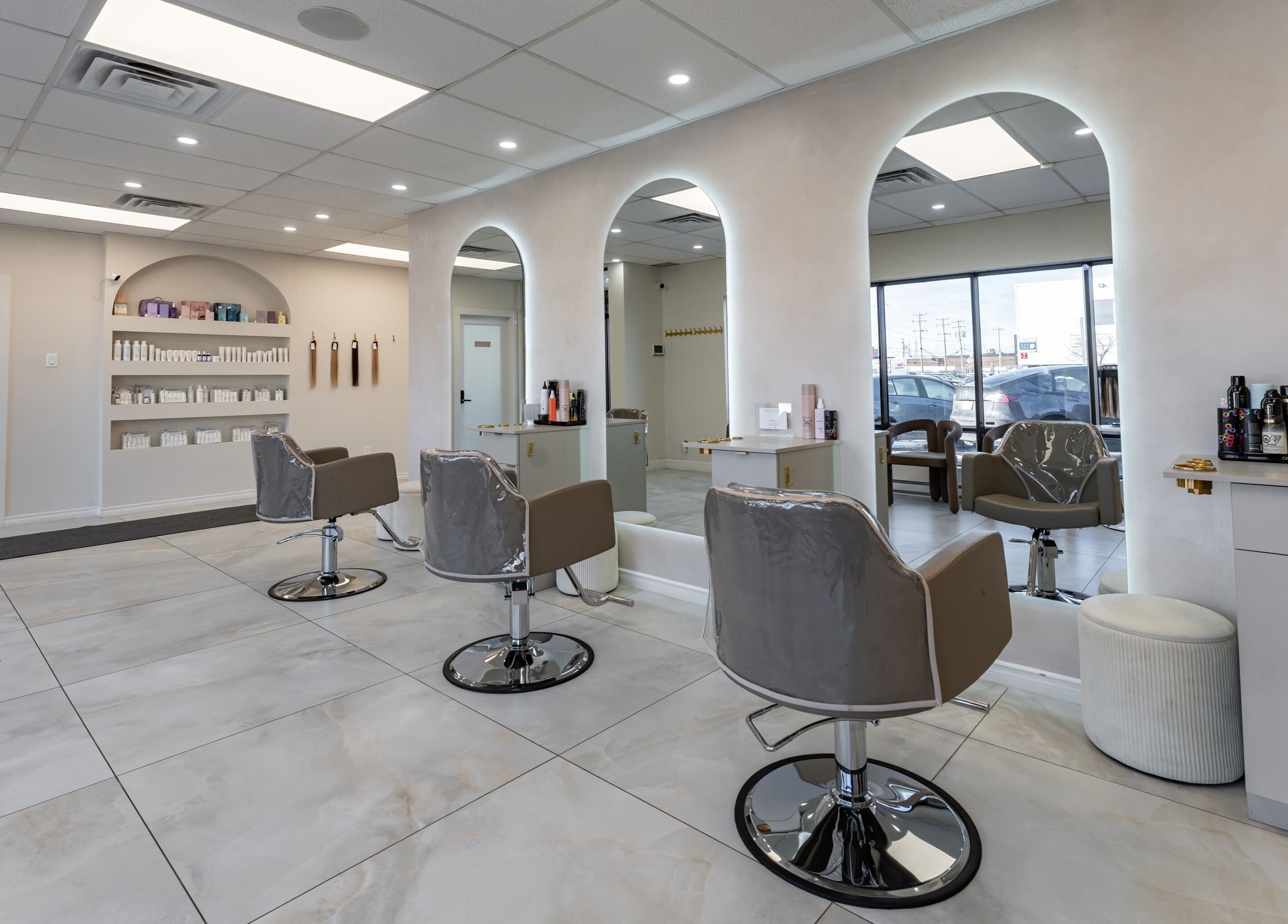 Chic interior of Haute Beauté salon with styling chairs and mirrors in Laval, Québec, CA.