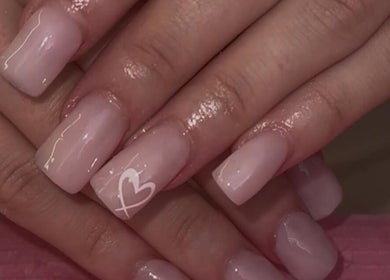 Elegant nude nails with heart accent at Beauty by Chloe🤍 in Edenbridge, England, GB.