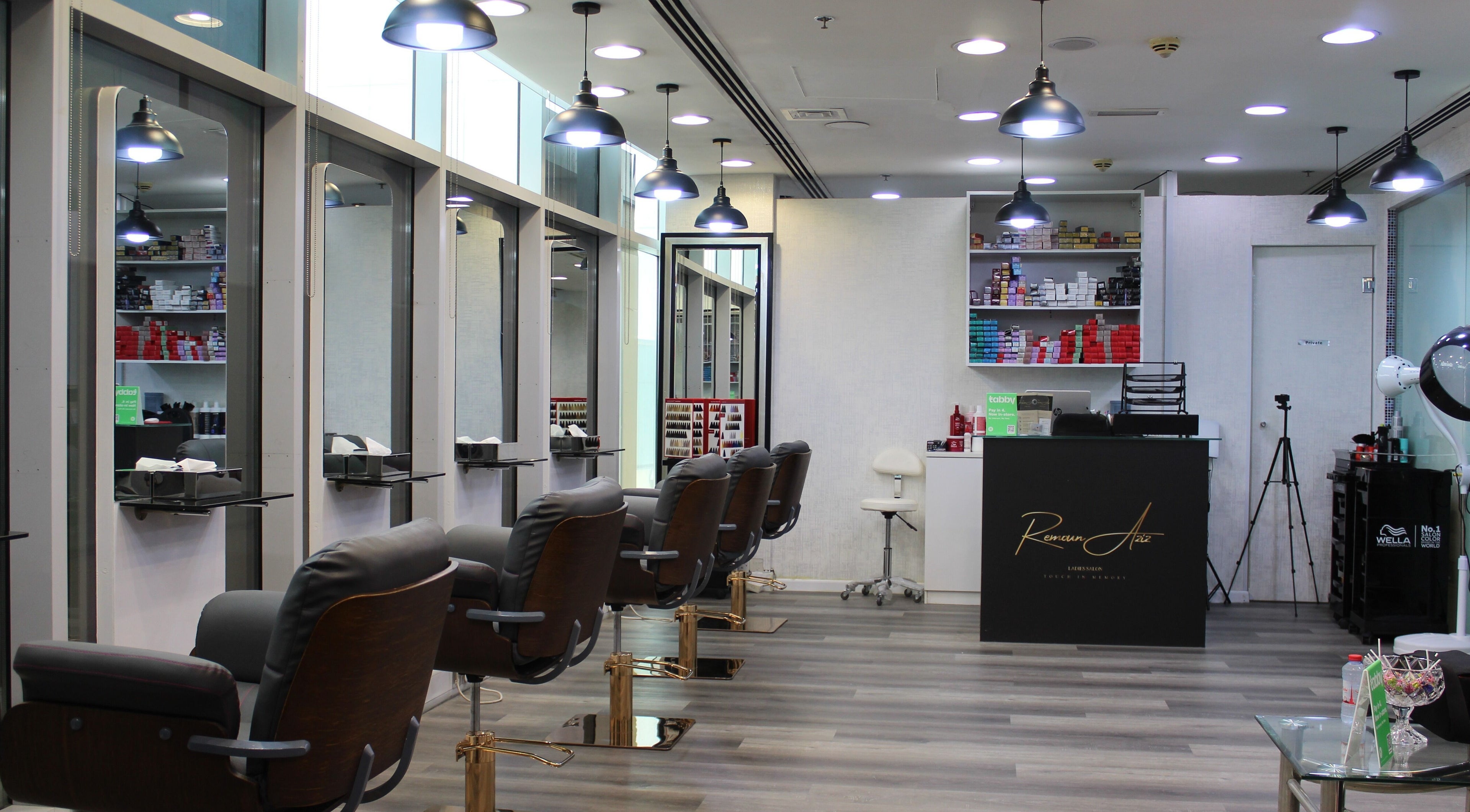 Modern interior of Remoun Aziz Ladies Salon in Dubai, Dubai, AE featuring elegant styling chairs and bright lighting.