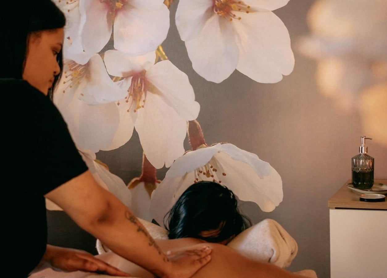Relaxing massage at Tashreeqah Verrie Massage Studio, Gqeberha, Eastern Cape, ZA amidst floral decor.