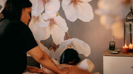 Relaxing massage at Tashreeqah Verrie Massage Studio, Gqeberha, Eastern Cape, ZA amidst floral decor.