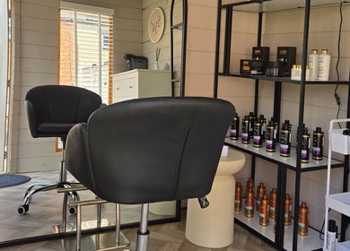 Stylish interior of Healthy Hair Studio Derby in Derby, England, GB with sleek chairs and premium hair products.