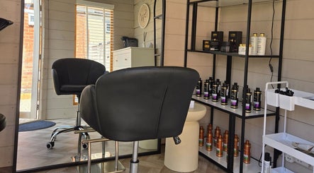 Stylish interior of Healthy Hair Studio Derby in Derby, England, GB with sleek chairs and premium hair products.