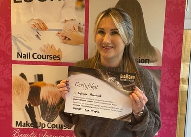 Graduate holding a certificate at Healthy Hair Studio Derby, Derby, England, GB, highlighting beauty courses.