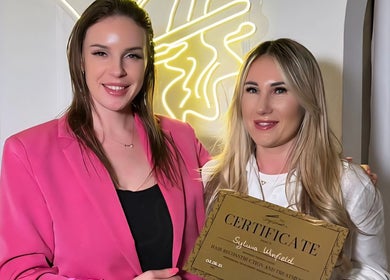 Two women celebrating a certificate at Healthy Hair Studio Derby, Derby, England, GB.