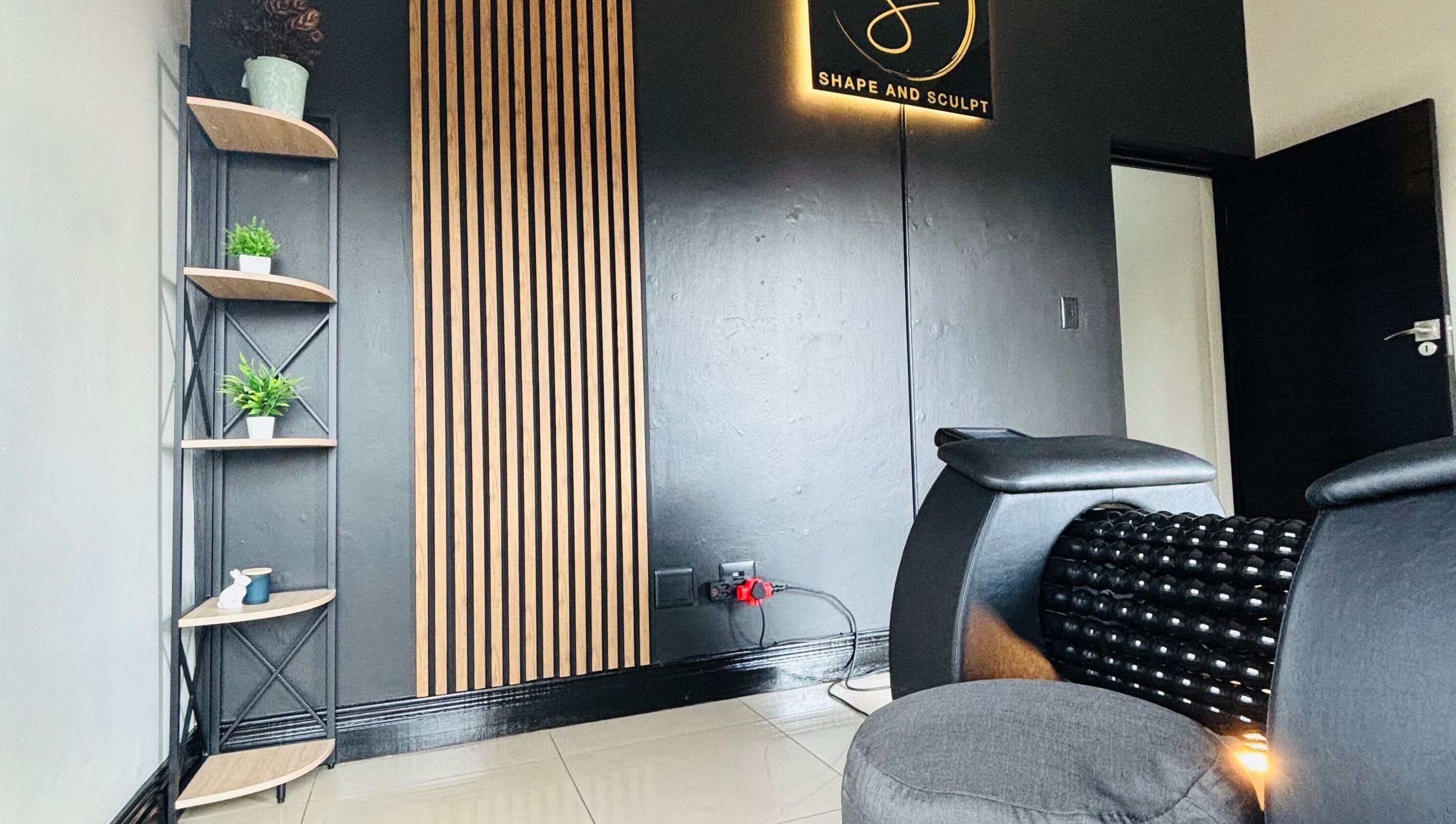 Stylish corner at Shape And Sculpt in Pretoria, Gauteng, ZA with black decor and green plants.