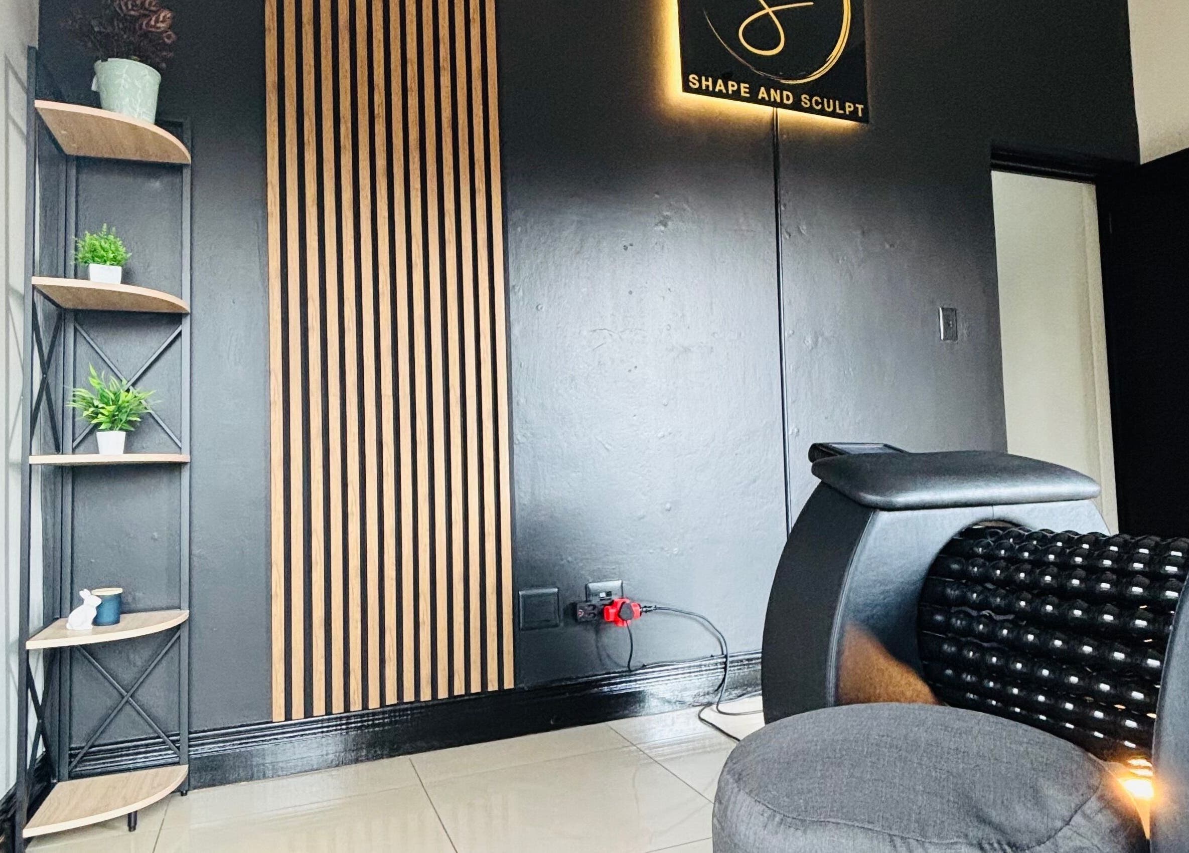 Stylish corner at Shape And Sculpt in Pretoria, Gauteng, ZA with black decor and green plants.