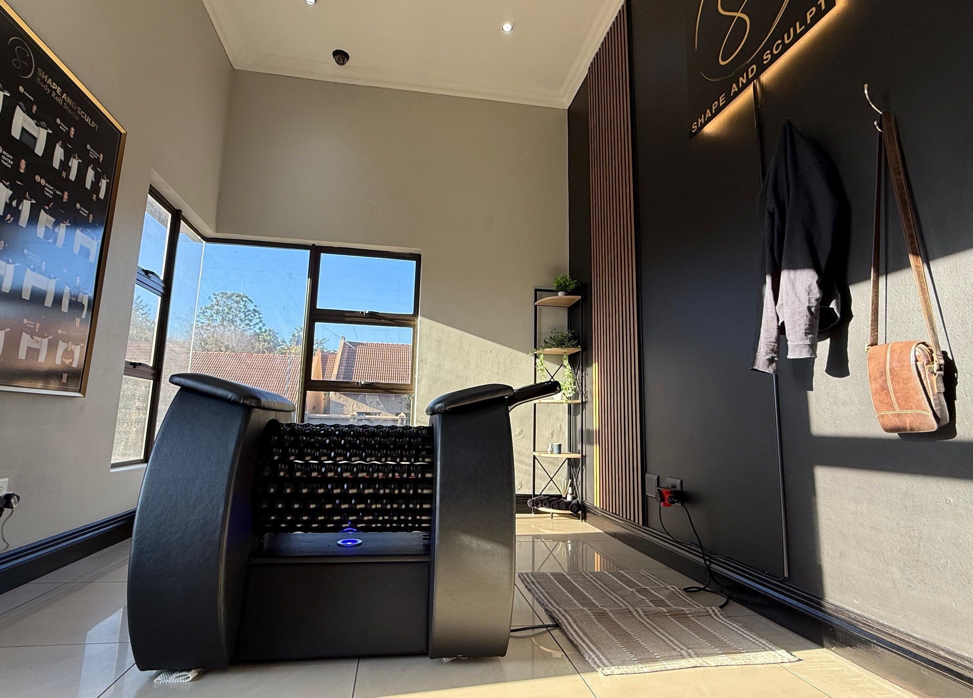 Modern wellness area at Shape And Sculpt in Pretoria, Gauteng, ZA with massage equipment and decor.