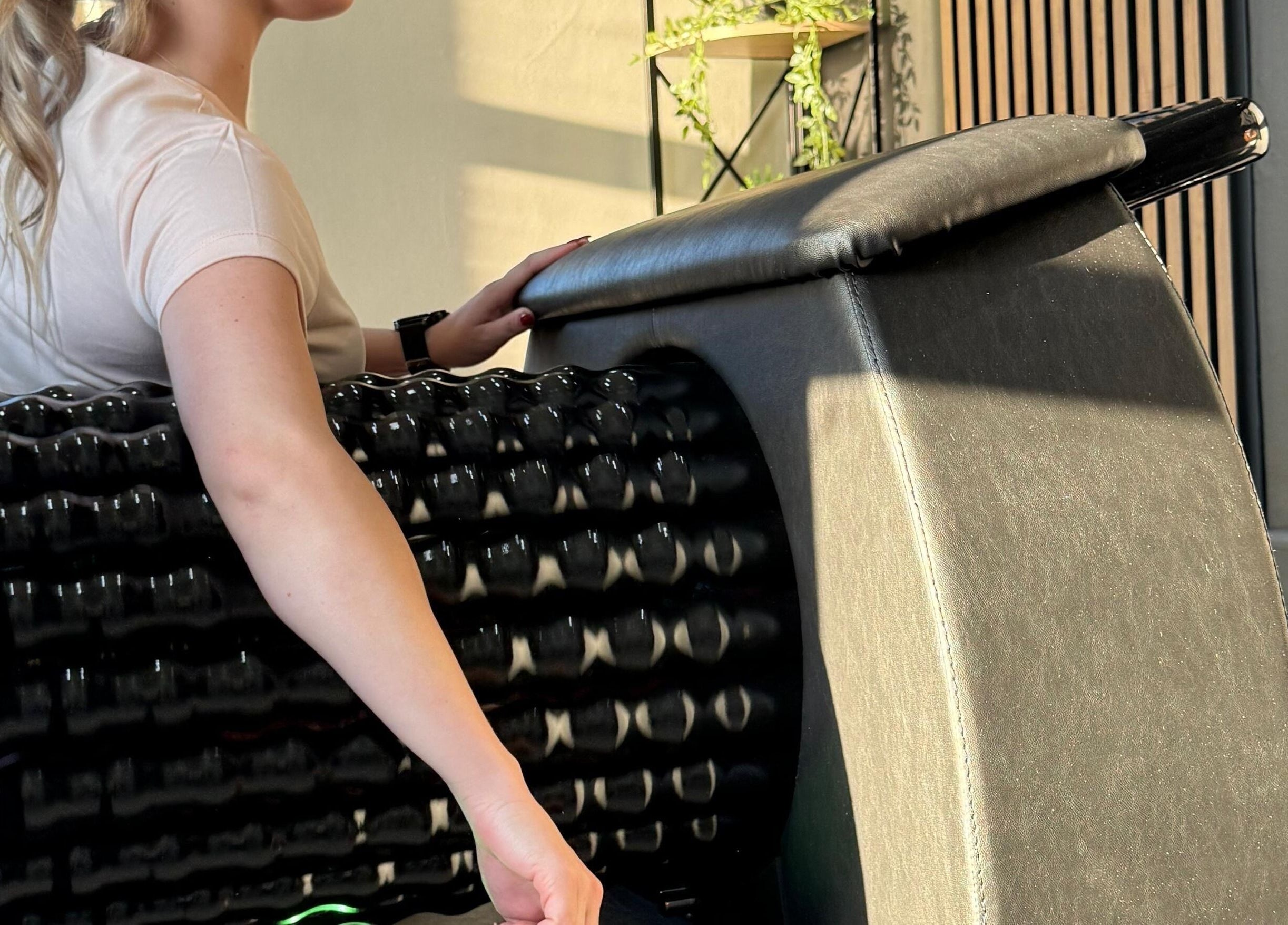A woman enjoys a relaxing massage roller at Shape And Sculpt, Pretoria, Gauteng, ZA.