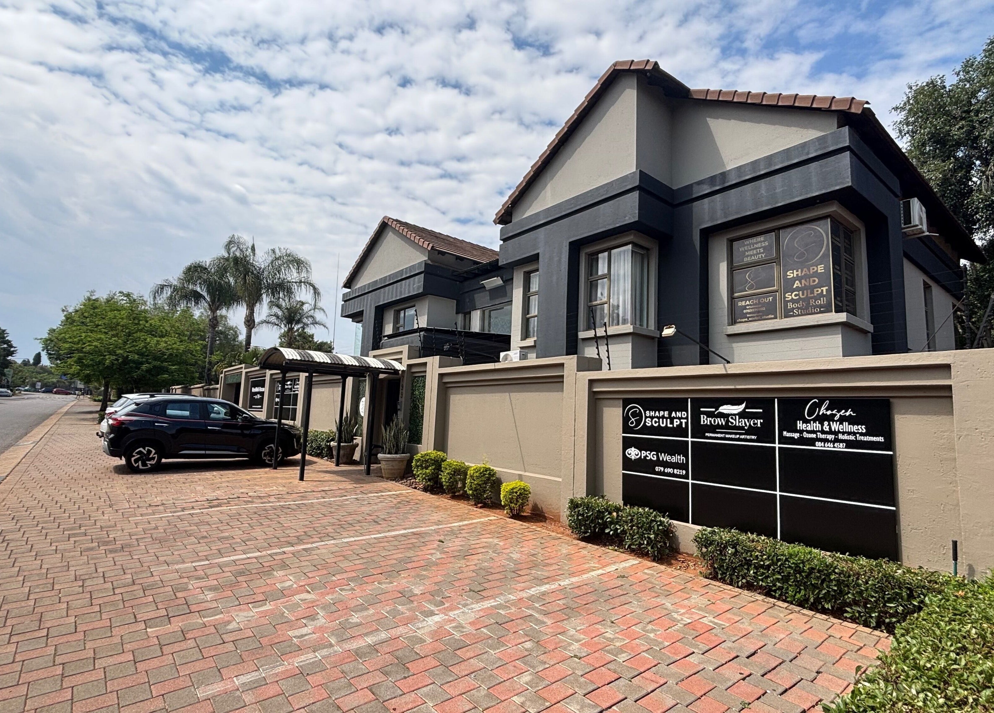 Exterior view of Shape And Sculpt in Pretoria, Gauteng, ZA, showcasing modern architecture and landscaped surroundings.