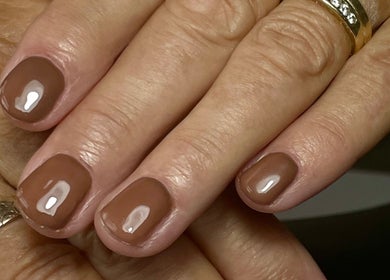 Elegant manicure in glossy brown at Nails by Delle, Dingwall, Scotland, GB.