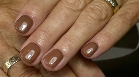 Elegant manicure in glossy brown at Nails by Delle, Dingwall, Scotland, GB.