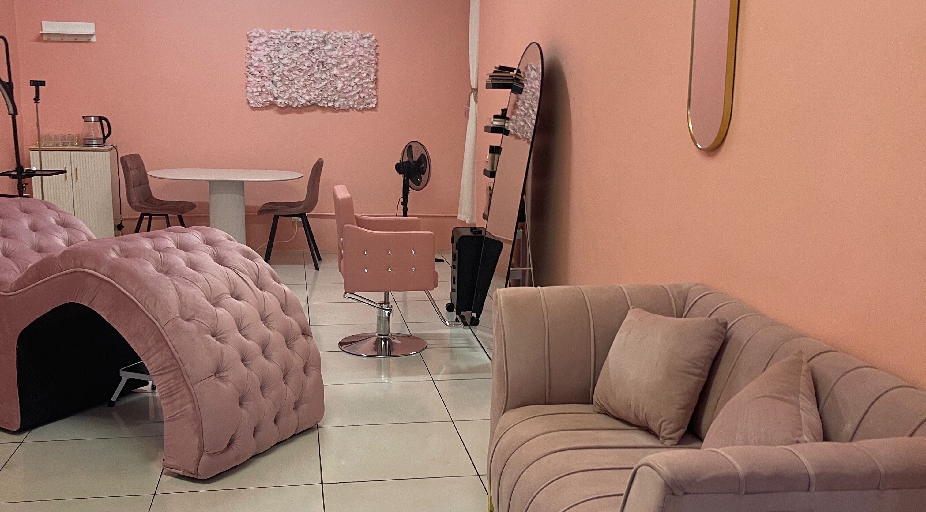 Inviting salon interior at Lee Aesthetics, Roodepoort, Gauteng, ZA with plush pink chairs and decor.