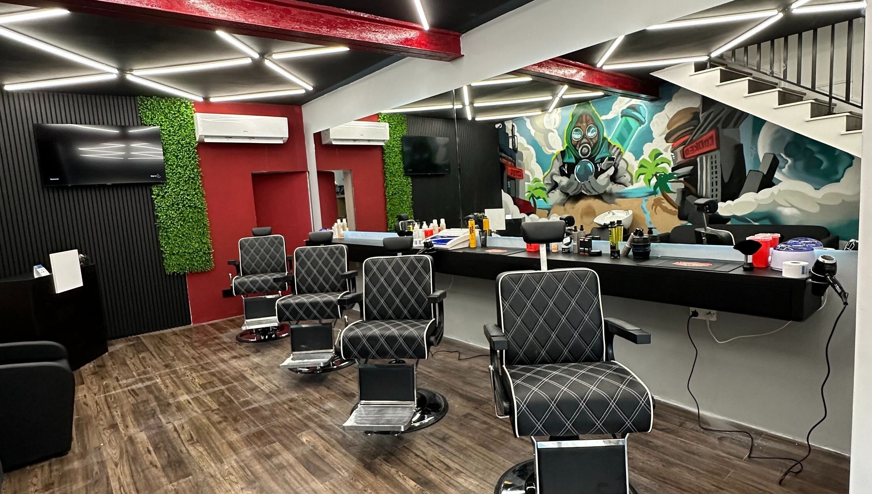 Modern barbershop interior at FRESH FADES | Sliema |, featuring stylish chairs and vibrant artwork in Sliema, Malta, MT.
