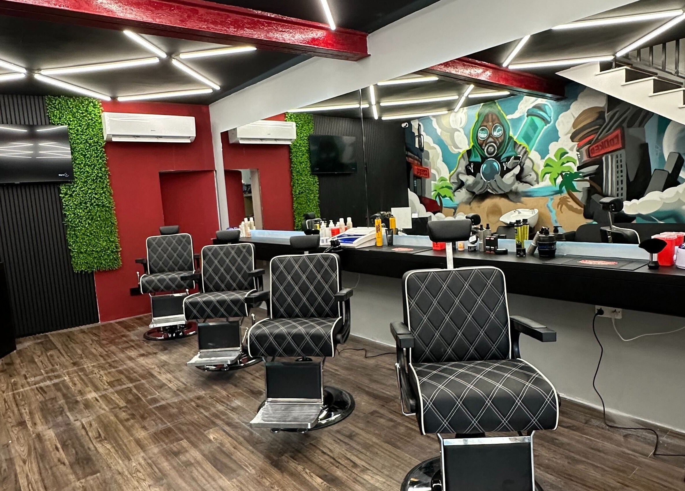 Modern barbershop interior at FRESH FADES | Sliema |, featuring stylish chairs and vibrant artwork in Sliema, Malta, MT.