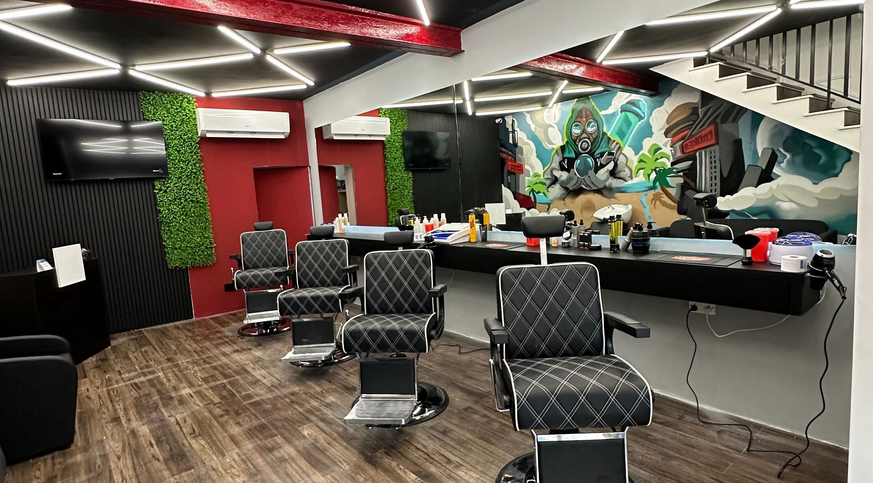 Modern barbershop interior at FRESH FADES | Sliema |, featuring stylish chairs and vibrant artwork in Sliema, Malta, MT.