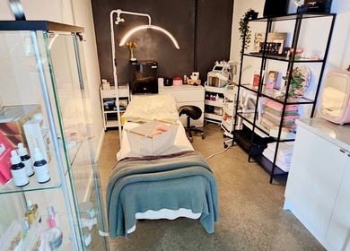 Relaxing treatment room at Laura May's Beauty, Joondalup, Western Australia, AU, featuring a cozy bed and products.