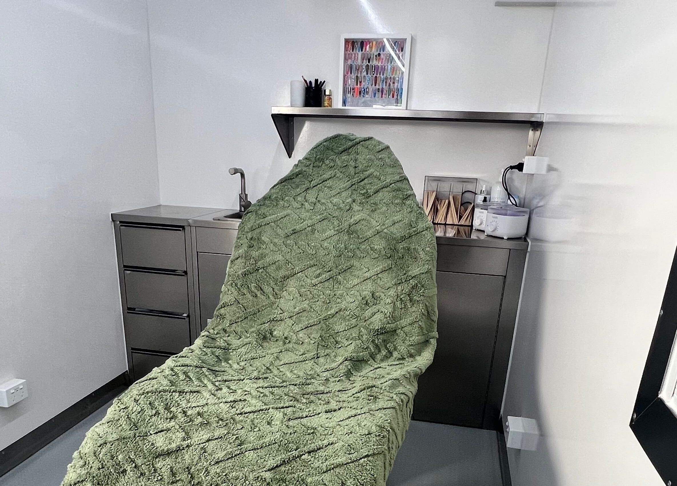 Cozy treatment room at Acryluxe Nails and Beauty, Dubbo, New South Wales, AU with plush green blanket.