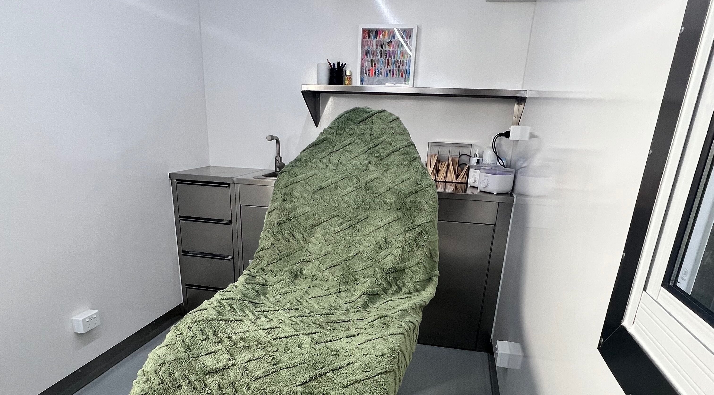 Cozy treatment room at Acryluxe Nails and Beauty, Dubbo, New South Wales, AU with plush green blanket.