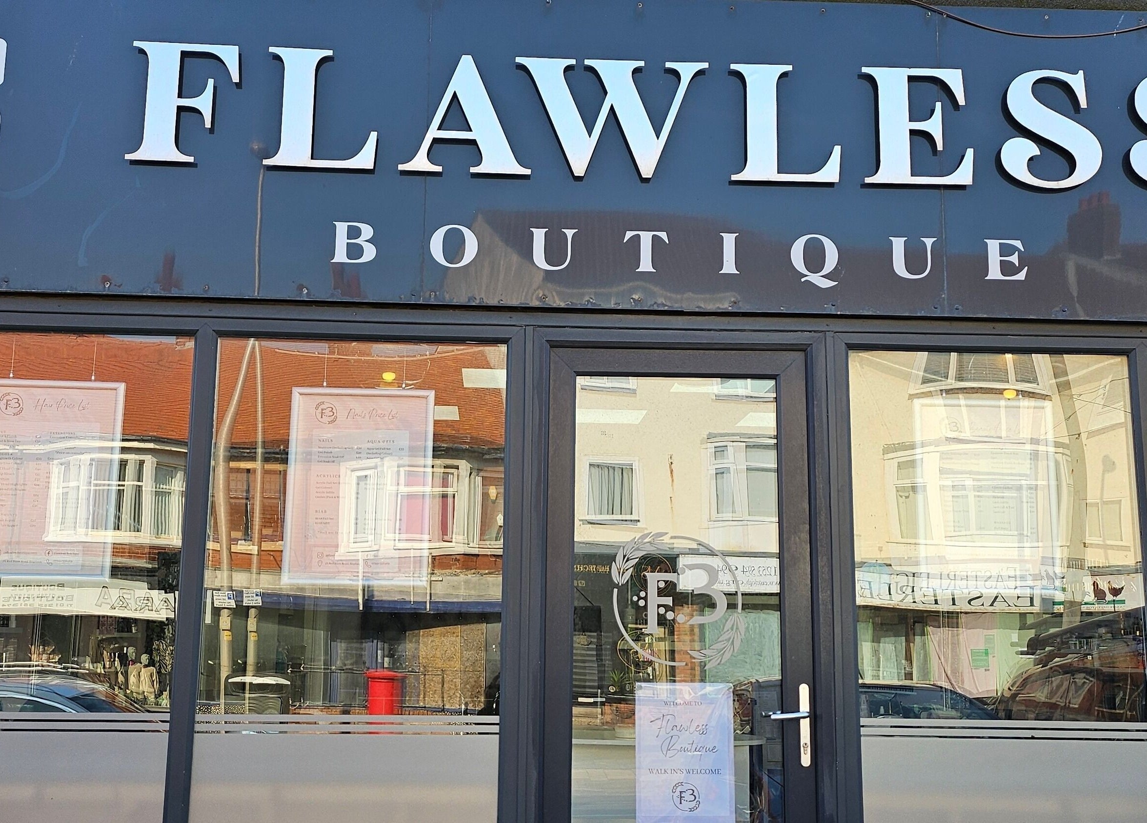Front view of Flawless Boutique Bispham, Blackpool, England, GB, showcasing elegant signage and glass entrance.