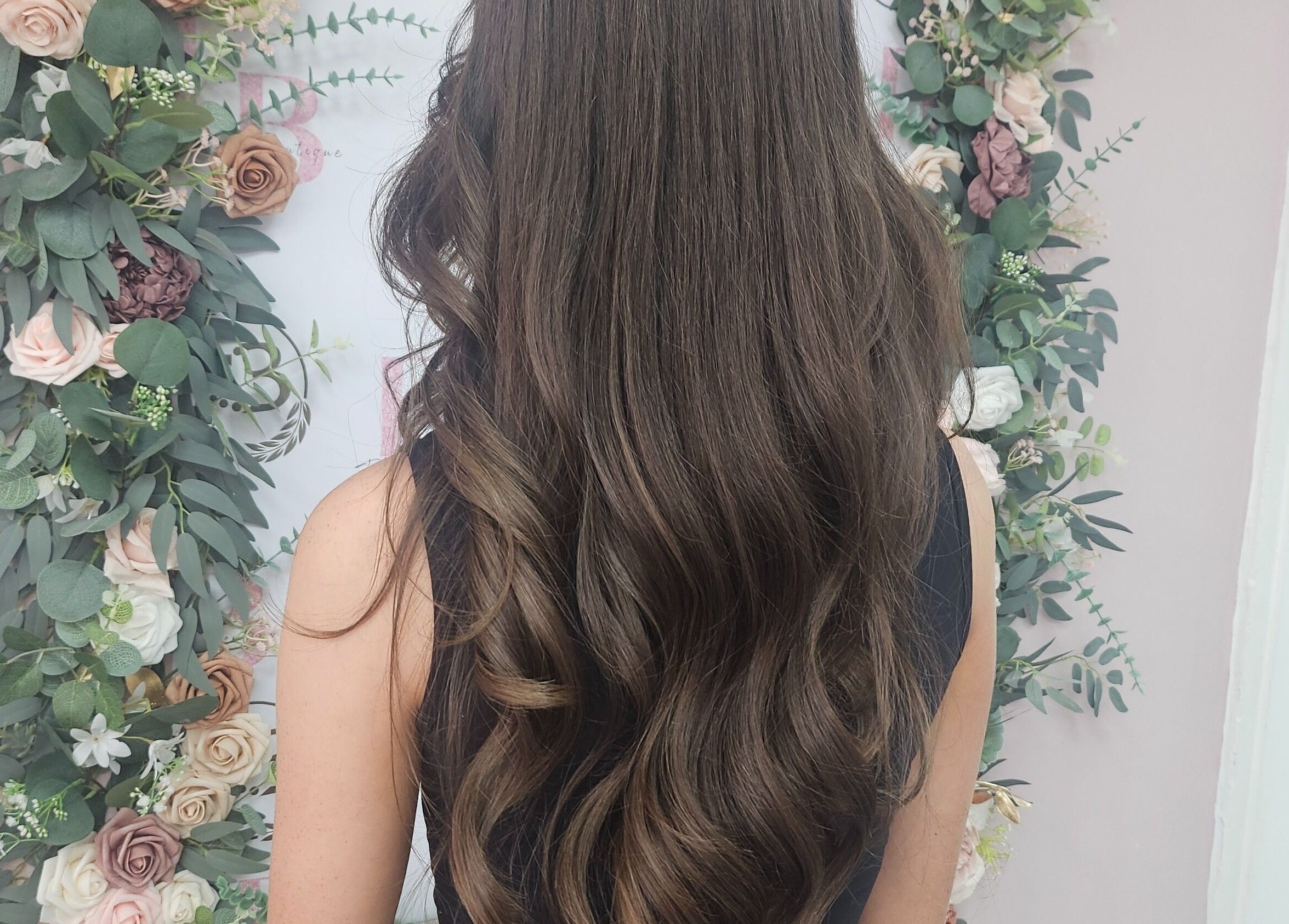 Beautiful long curls styled at Flawless Boutique Bispham, Blackpool, England, GB with floral backdrop.