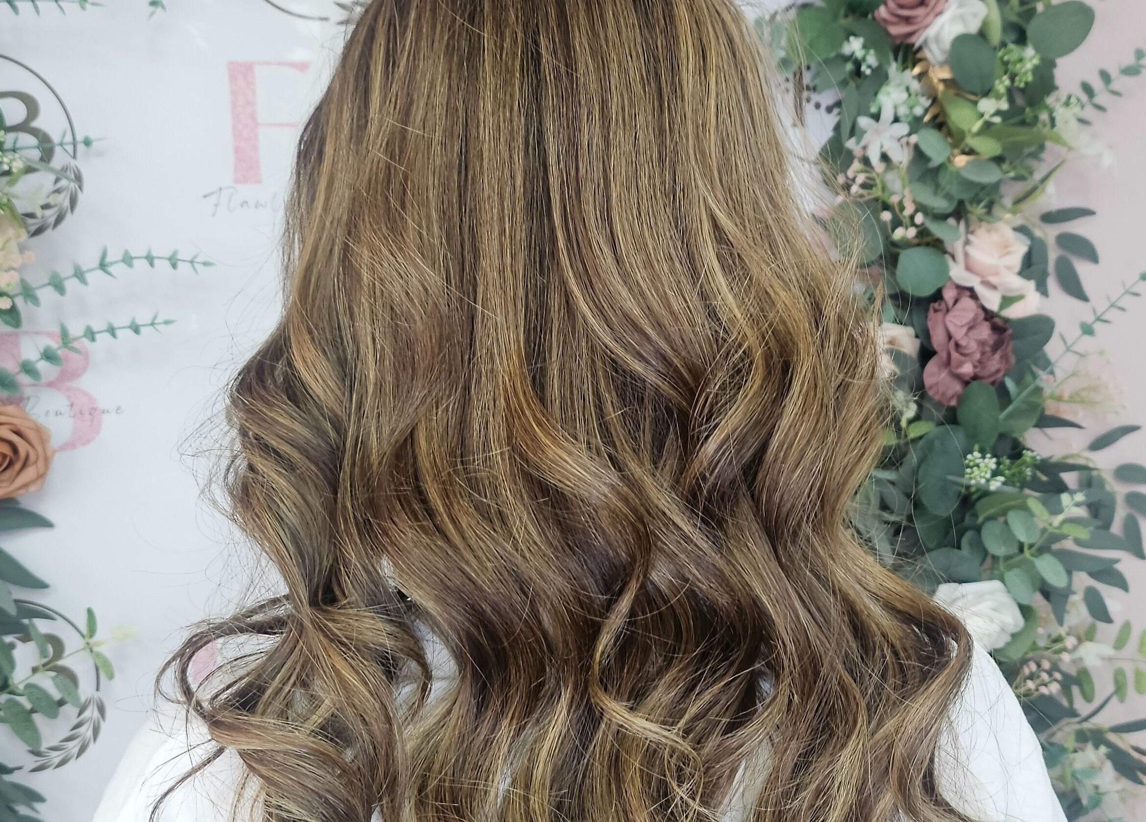 Elegant golden curls styled at Flawless Boutique Bispham in Blackpool, England, GB, framed by floral decor.