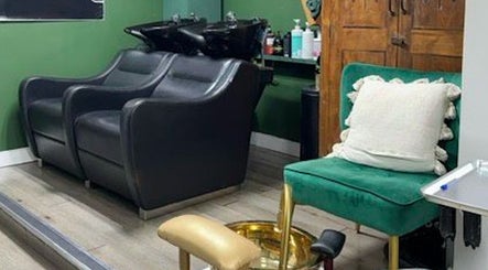 Stylish seating area at A&S Hair and Beauty Salon, London, England, GB showcasing elegant black chairs.