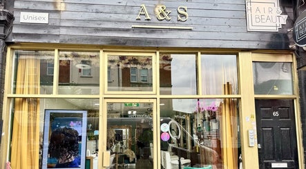 Front view of A&S Hair and Beauty Salon in London, England, GB with large windows and signage.