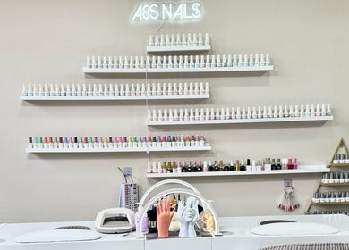 Nail polish shelves at A&S Hair and Beauty Salon in London, England, GB showcasing vibrant color selections.