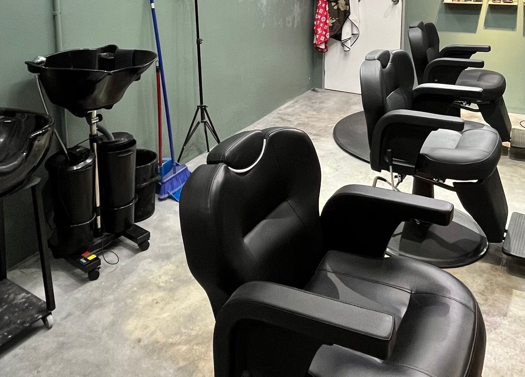 Modern barber chairs at Ayos Barbershop in Batu Caves, Selangor, MY showcasing sleek design and comfort.