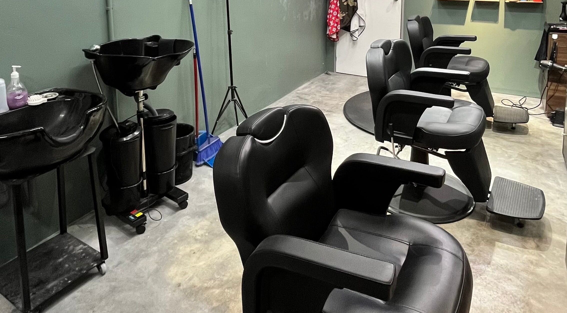 Modern barber chairs at Ayos Barbershop in Batu Caves, Selangor, MY showcasing sleek design and comfort.