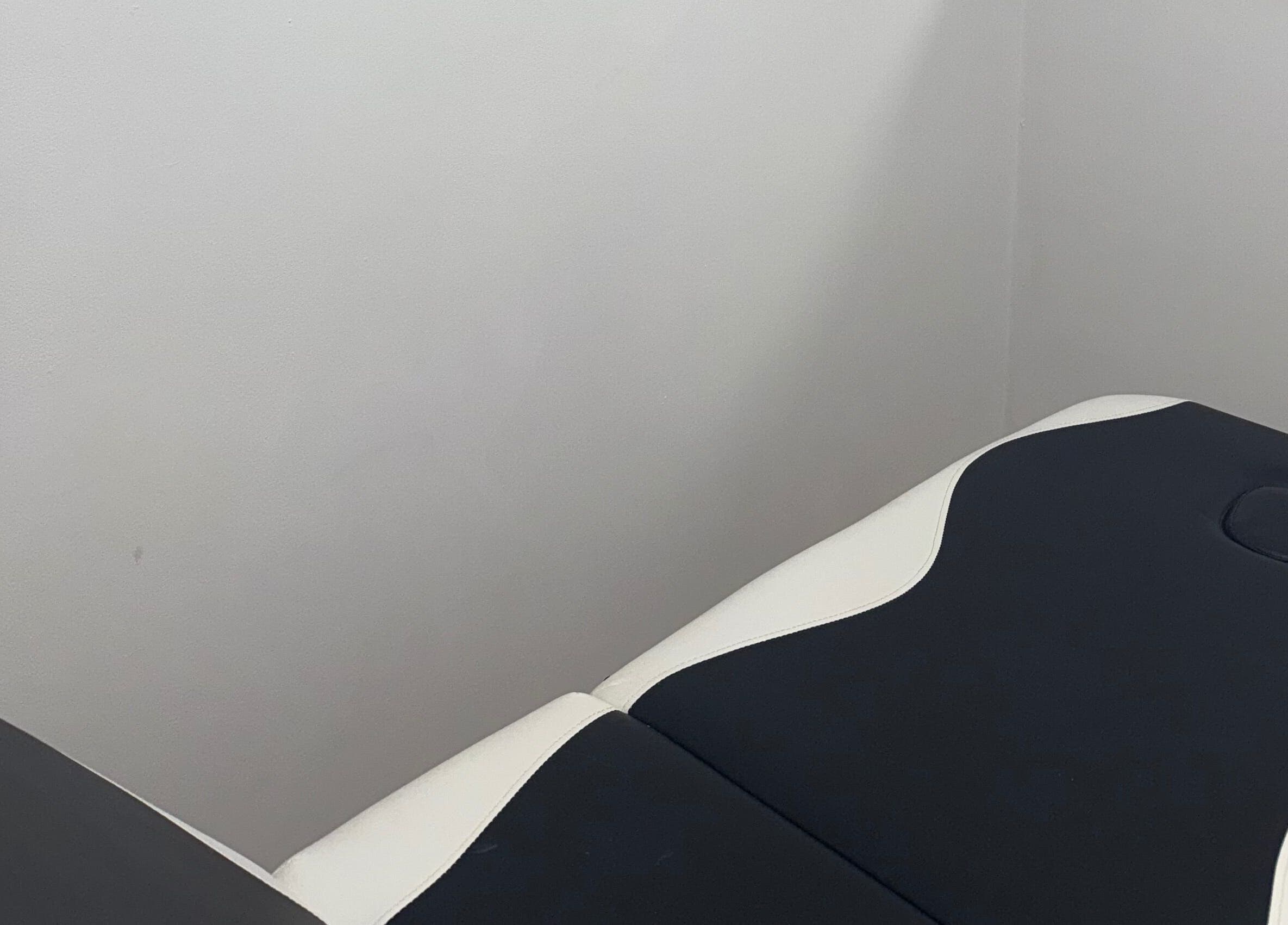 Massage table at Nu Faces by Georgina in Wakefield, England, GB, ready for spa treatments in a tranquil setting.