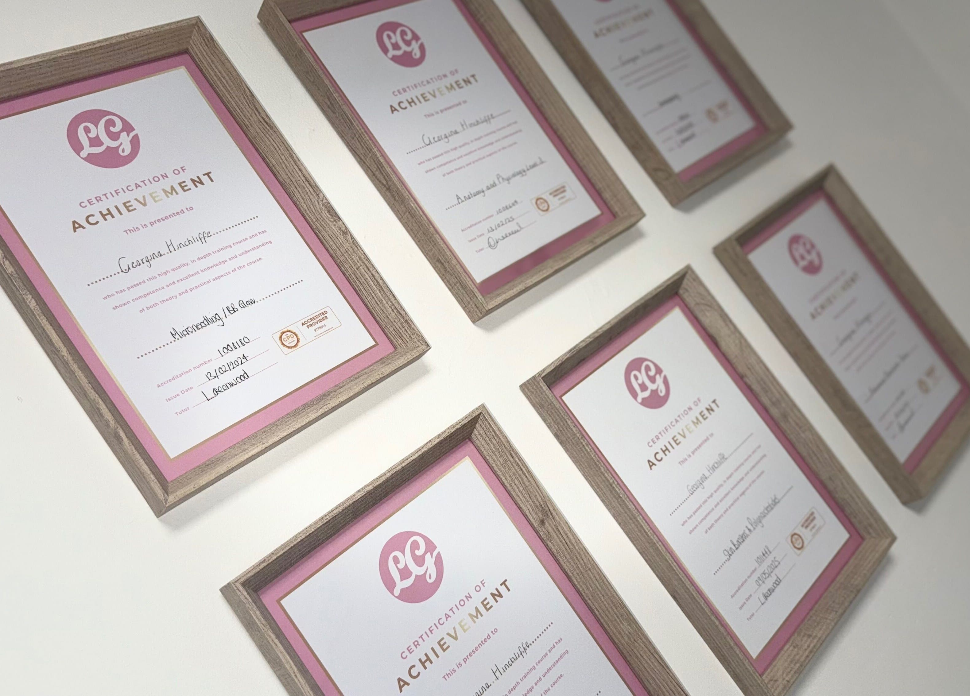 Framed certificates on the wall at Nu Faces by Georgina, Wakefield, England, GB, showcasing accomplishments.