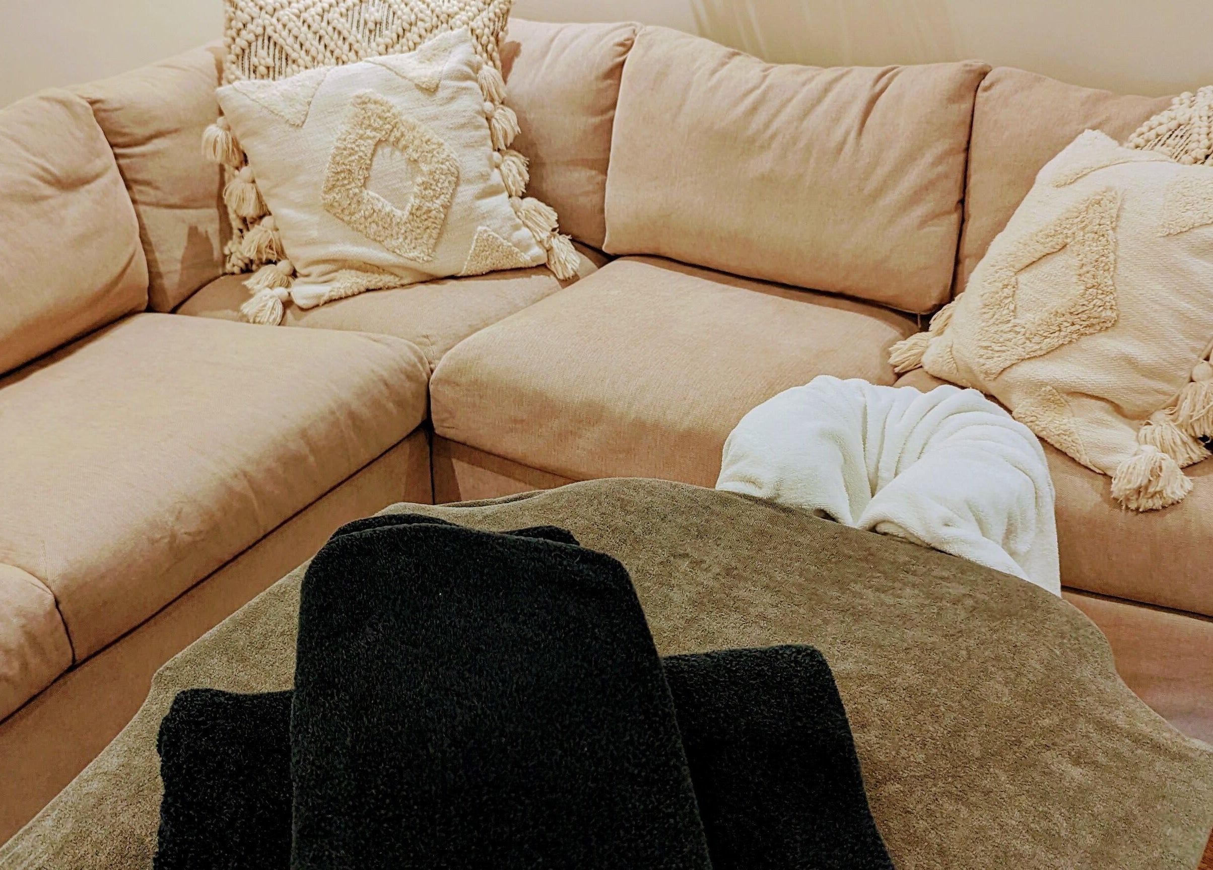 Inviting massage setup at Liz's Mobile Massage Faversham, featuring beige sofa with plush cushions, Faversham, England, GB.