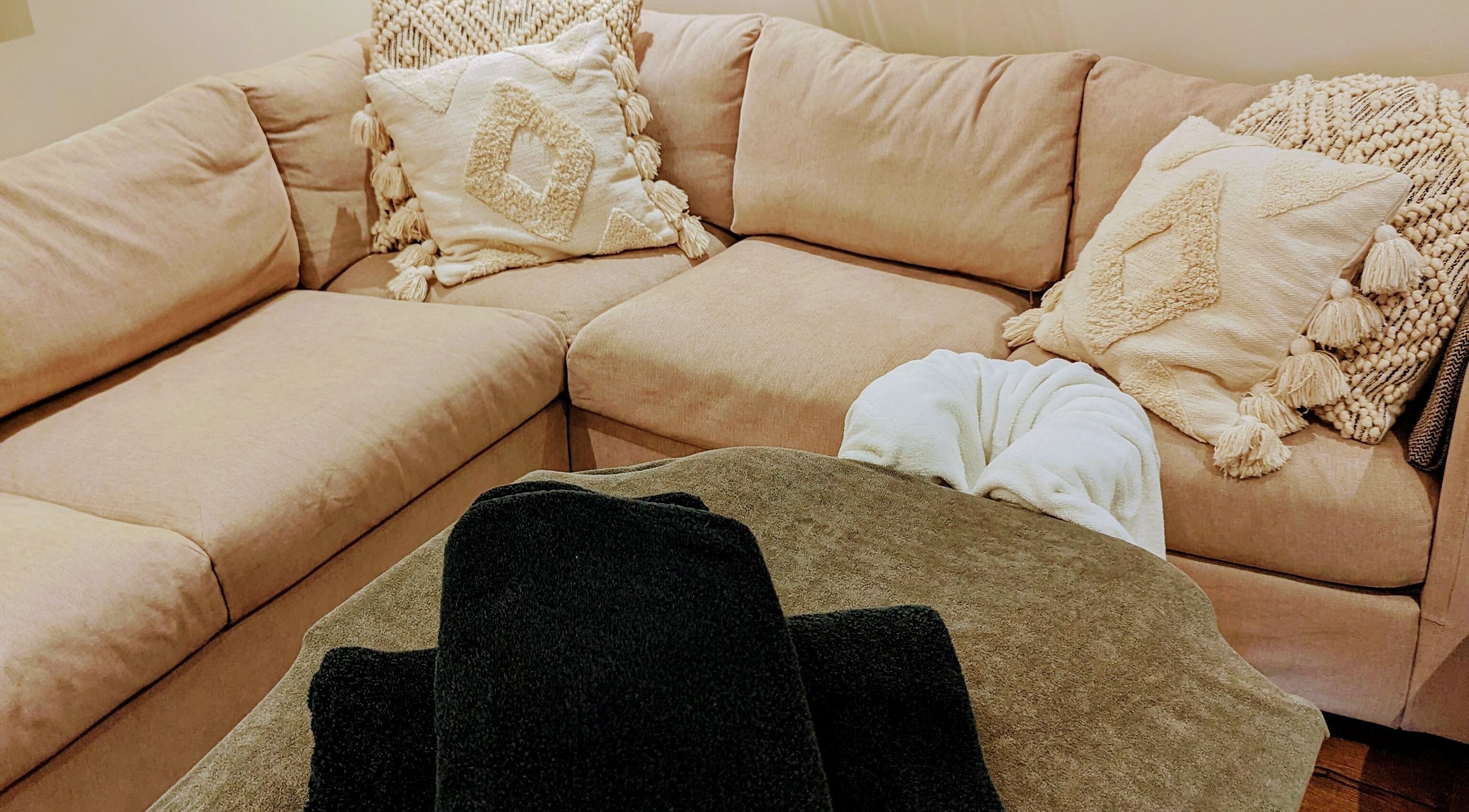 Inviting massage setup at Liz's Mobile Massage Faversham, featuring beige sofa with plush cushions, Faversham, England, GB.