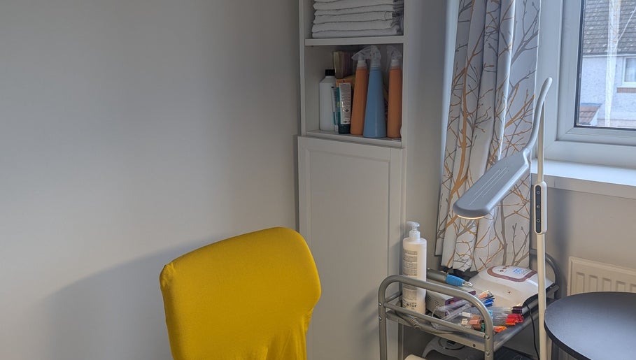 Bright yellow chair and organized nail supplies at Agi Nails, Bulwark, Wales, GB.